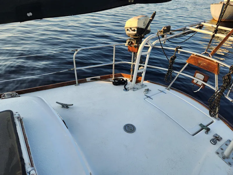 Slide: The Image of 1979 Morgan 45 Ketch sailboat deck with calm water backdrop. - 43