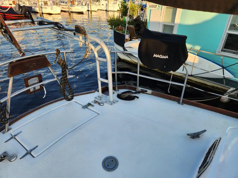 Slide: The Image of 1979 Morgan 45 Ketch sailboat deck with marina view. - 44