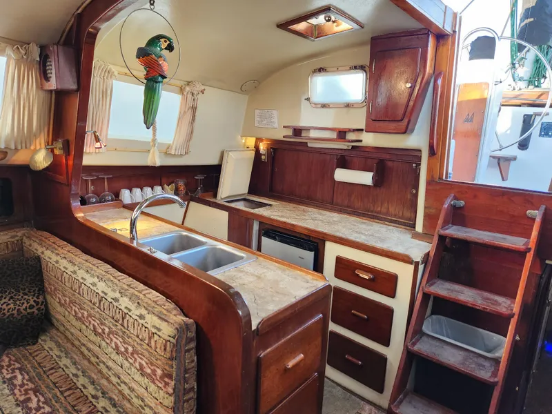 Slide: The Image of Interior of 1979 Morgan 45 Ketch sailboat with kitchen and seating area. - 47