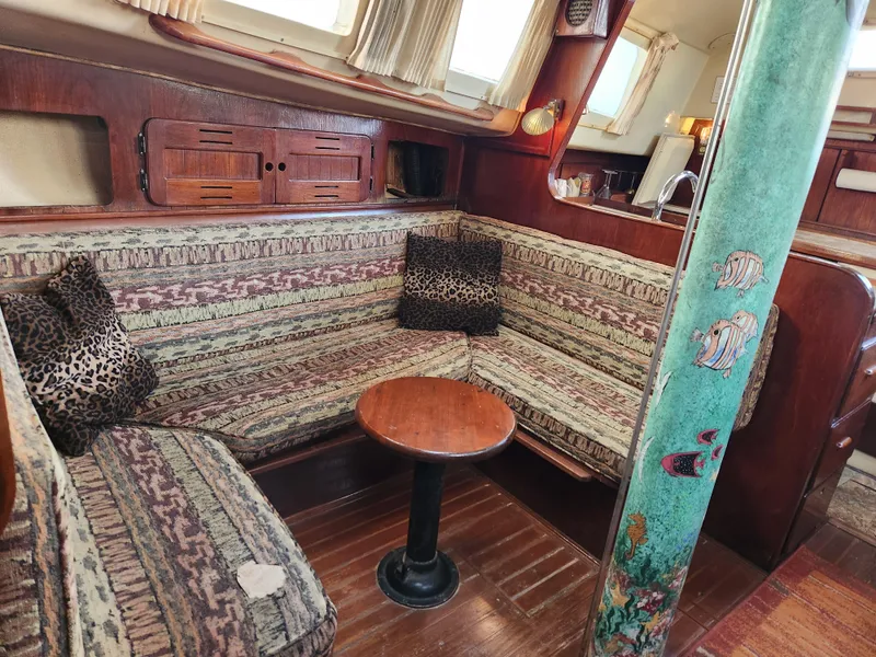 Slide: The Image of Interior of 1979 Morgan 45 Ketch sailboat with cozy seating and wooden table. - 56