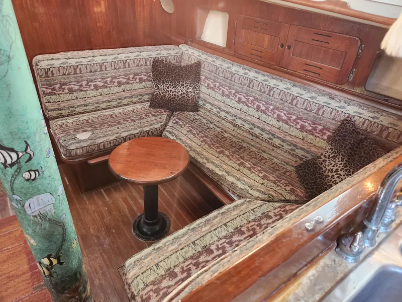 Slide: The Image of Cozy interior of 1979 Morgan 45 Ketch with patterned seating and wooden accents. - 57