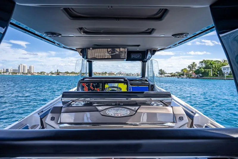 Slide: The Image of 2023 Nor-Tech 500 Sport boat interior with ocean view and modern dashboard. - 15