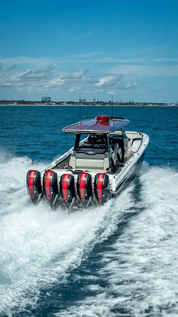 Slide: The Image of 2023 Nor-Tech 500 Sport boat speeding on open water with powerful engines. - 26