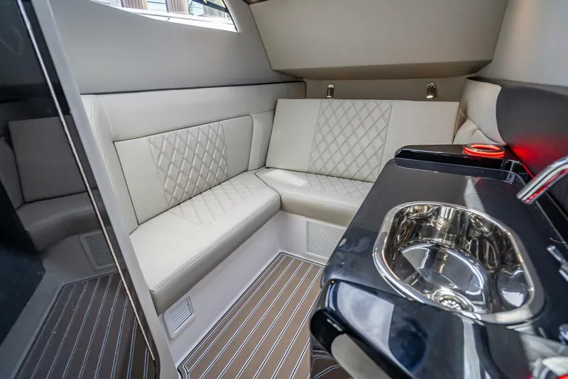 Slide: The Image of Luxurious interior of 2023 Nor-Tech 500 Sport boat with plush seating and sleek sink. - 31