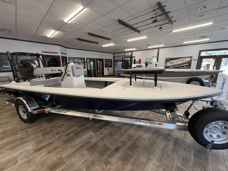 Slide: The Image of 2025 Maverick 18 HPX-V boat displayed indoors on a trailer. - 1