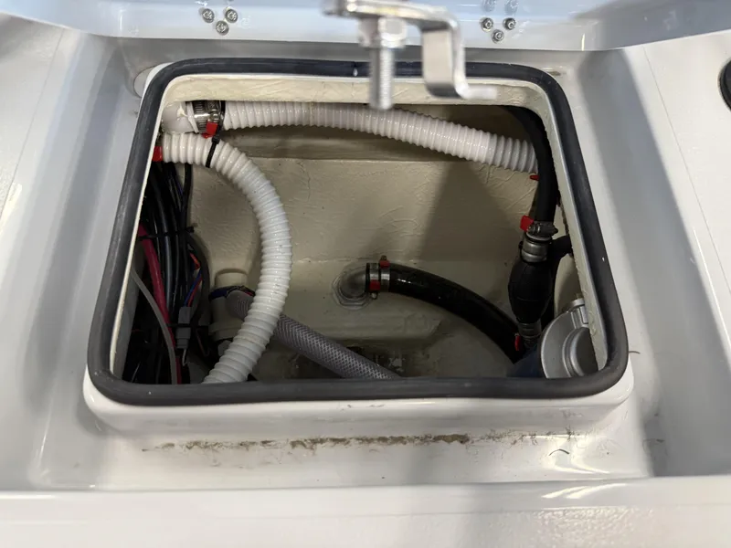 Slide: The Image of Open hatch of 2025 Maverick 18 HPX-V boat showing internal wiring and hoses. - 23