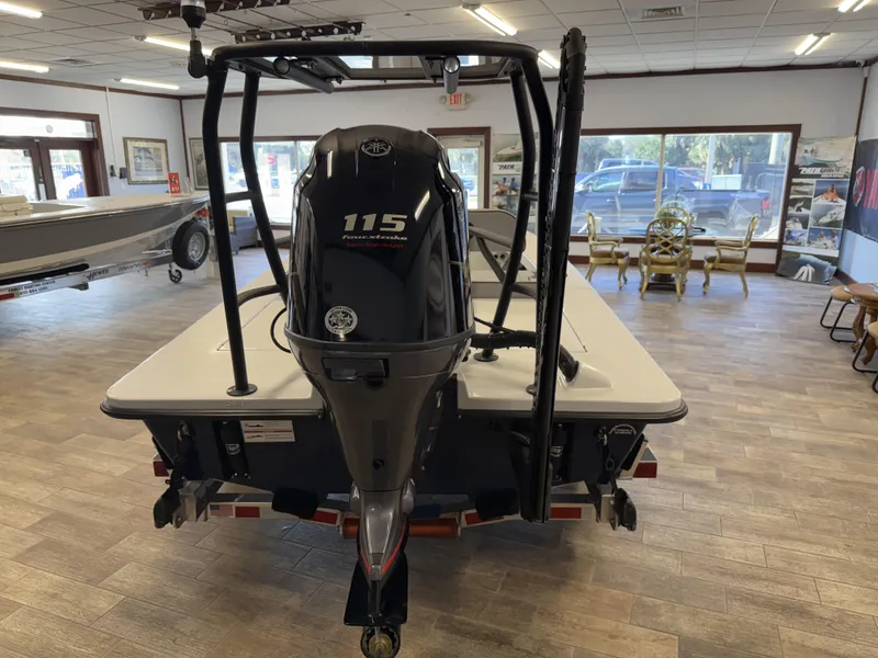 Slide: The Image of 2025 Maverick 18 HPX-V boat with 115 HP engine displayed indoors. - 3