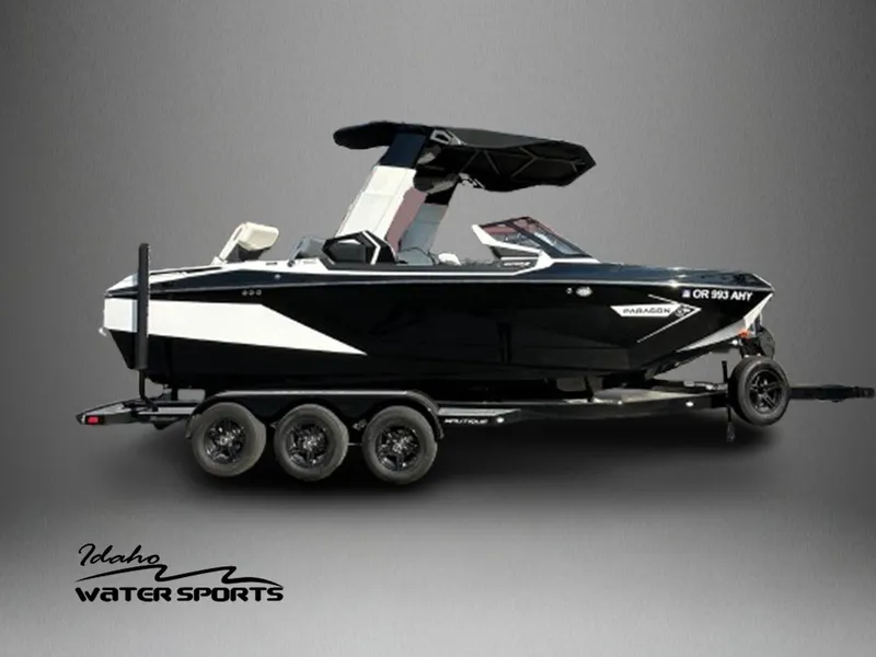 Slide: The Image of 2023 Nautique PARAGON 23 boat on trailer, Idaho Water Sports logo, side view. - 1