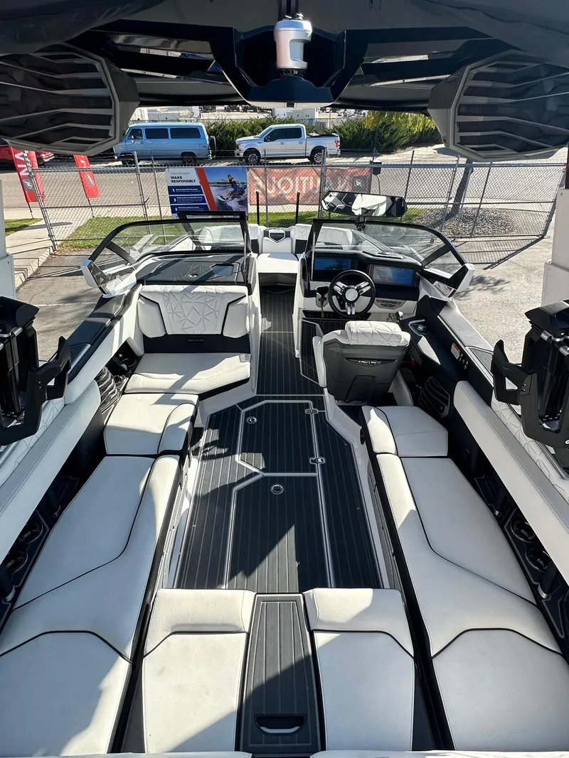 Slide: The Image of 2023 Nautique PARAGON 23 boat interior with luxurious seating and modern dashboard. - 11