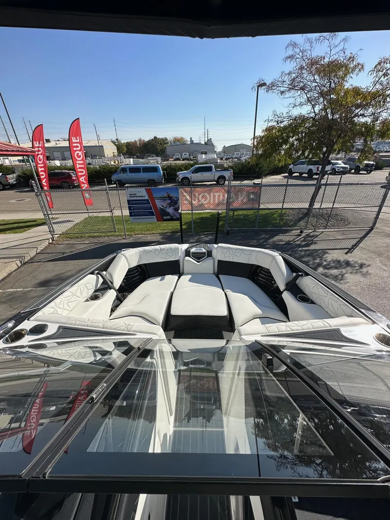 Slide: The Image of 2023 Nautique PARAGON 23 boat with luxurious seating, displayed outdoors. - 12