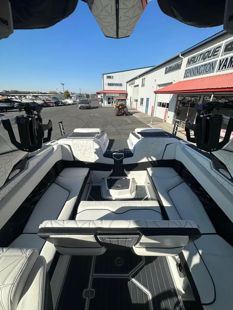 Slide: The Image of 2023 Nautique PARAGON 23 boat interior with luxurious seating at a dealership. - 15