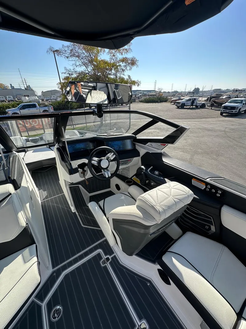 Slide: The Image of 2023 Nautique PARAGON 23 boat interior with modern dashboard and luxurious seating. - 19