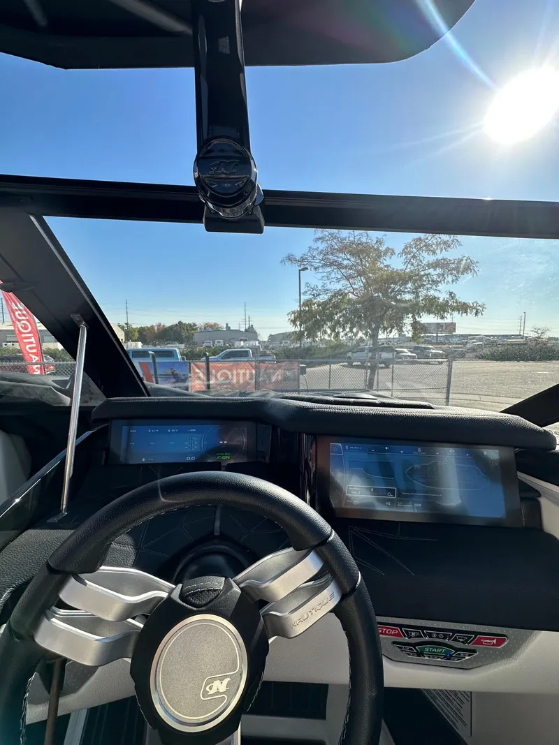 Slide: The Image of 2023 Nautique PARAGON 23 dashboard with steering wheel and digital displays. - 20
