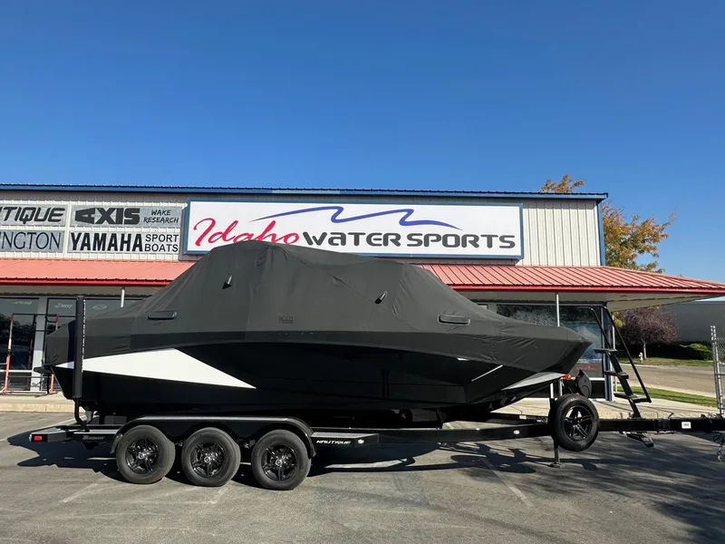 Slide: The Image of 2023 Nautique PARAGON 23 boat covered, parked at Idaho Water Sports dealership. - 3