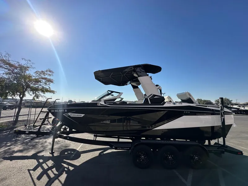 Slide: The Image of 2023 Nautique PARAGON 23 boat on trailer under bright sunlit sky. - 7