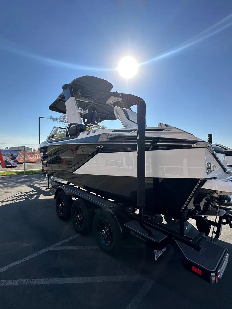 Slide: The Image of 2023 Nautique PARAGON 23 boat on trailer under bright sun. - 8