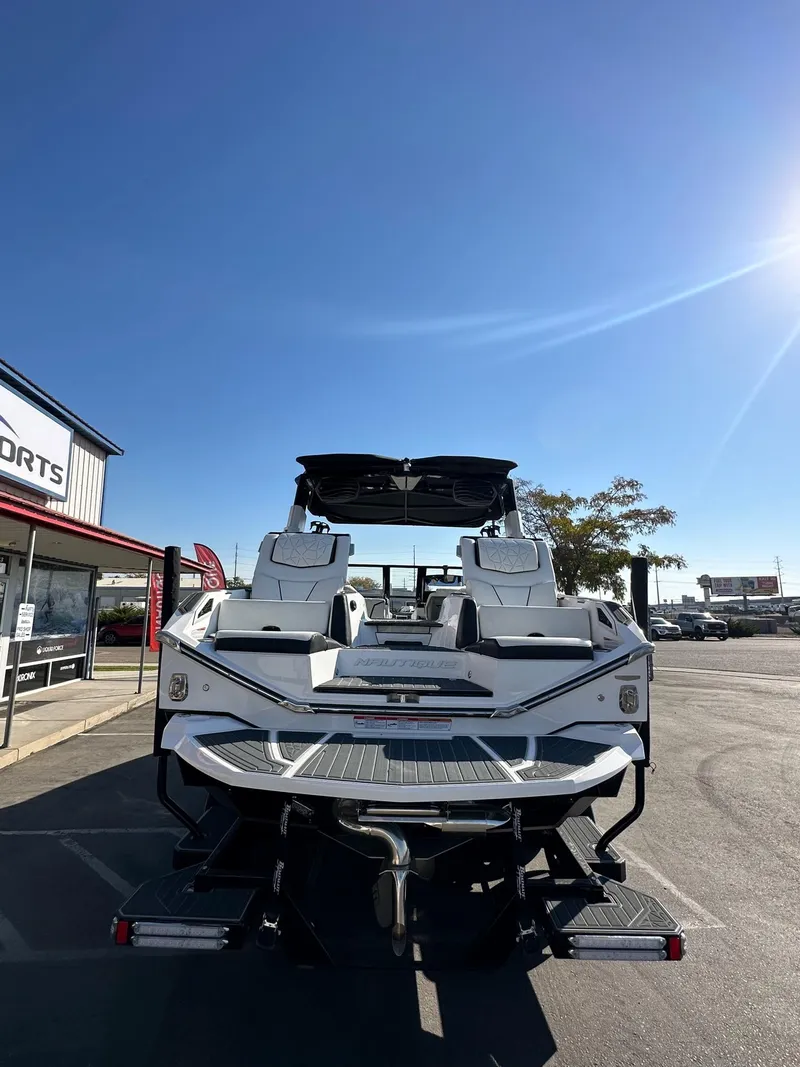 Slide: The Image of 2023 Nautique PARAGON 23 boat displayed outdoors under clear blue sky. - 9