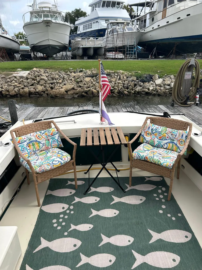 Slide: The Image of 1996 Mast & Mallet 34 Rabbit Custom boat with colorful seating and fish-patterned rug. - 13