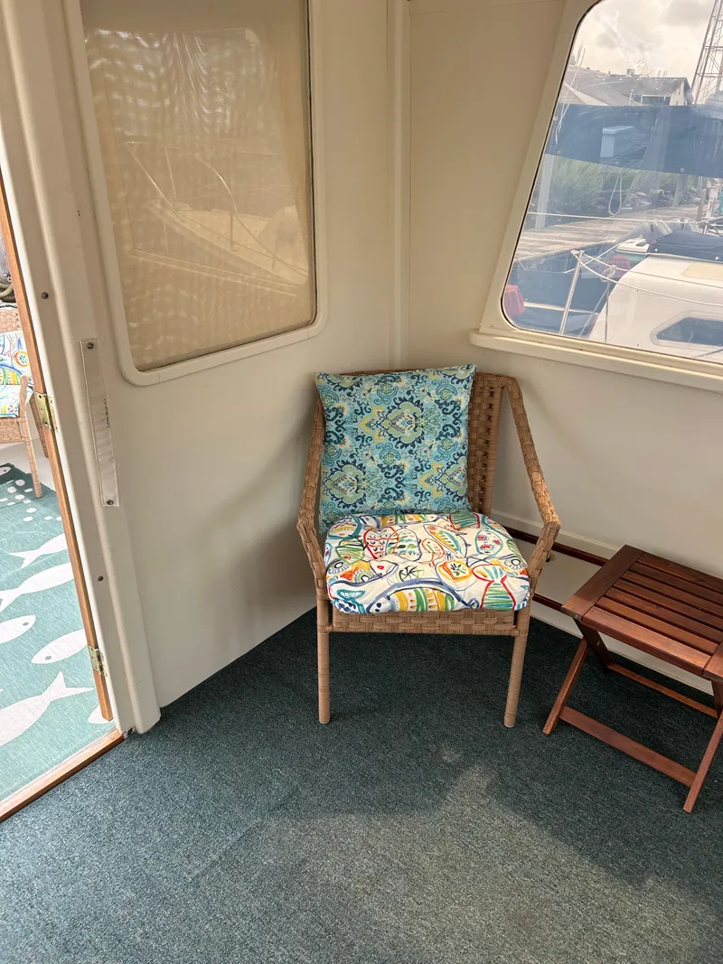 Slide: The Image of Cozy seating area on 1996 Mast & Mallet 34 Rabbit Custom boat with colorful cushions. - 16