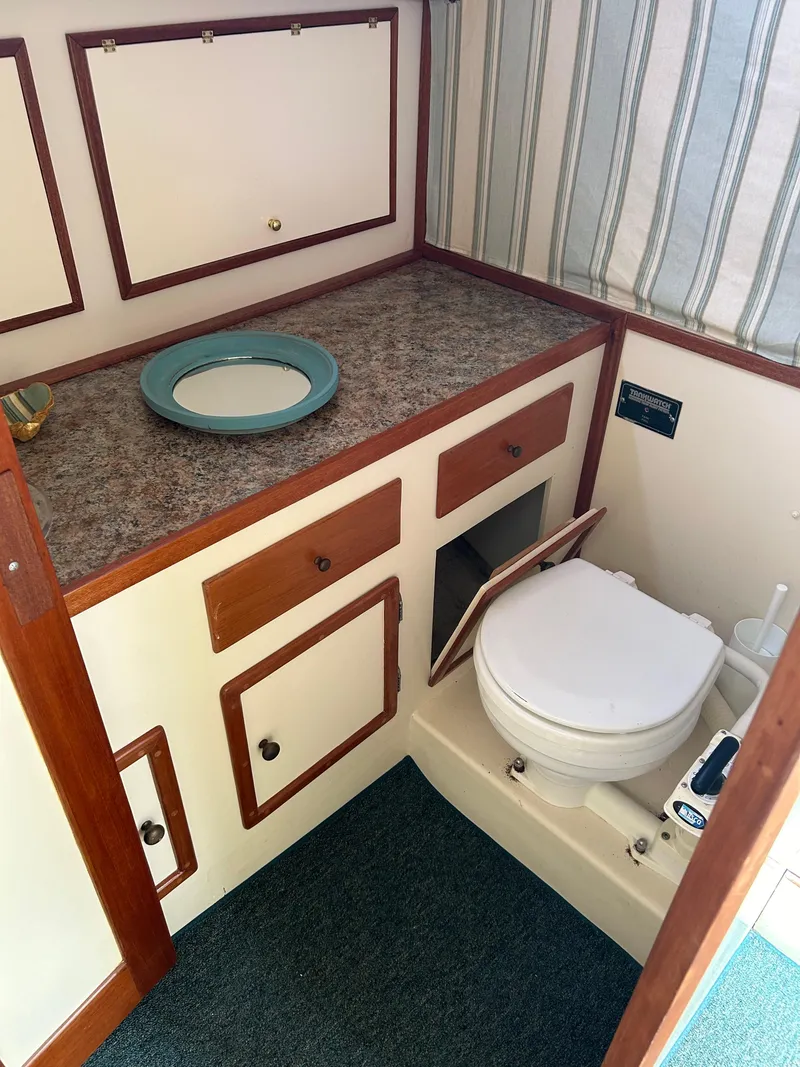 Slide: The Image of 1996 Mast & Mallet 34 Rabbit Custom boat bathroom with sink and toilet. - 26