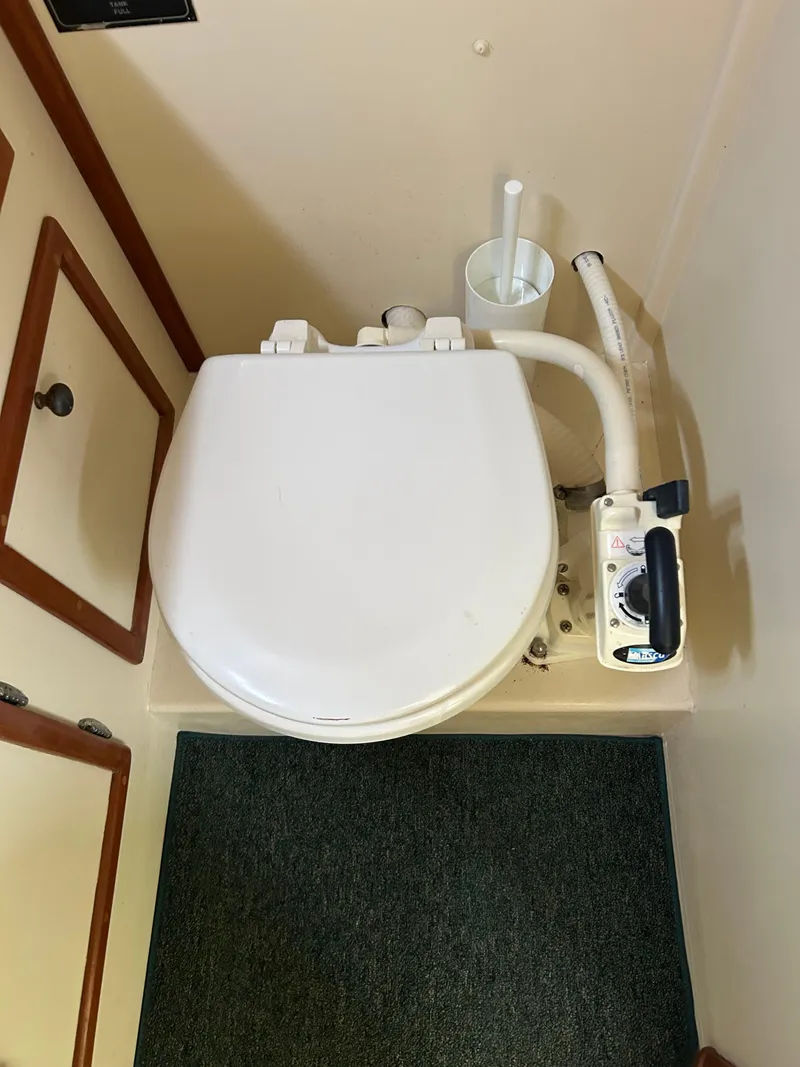 Slide: The Image of Boat bathroom with toilet and cleaning brush, Mast & Mallet 34 Rabbit Custom, 1996 model. - 28
