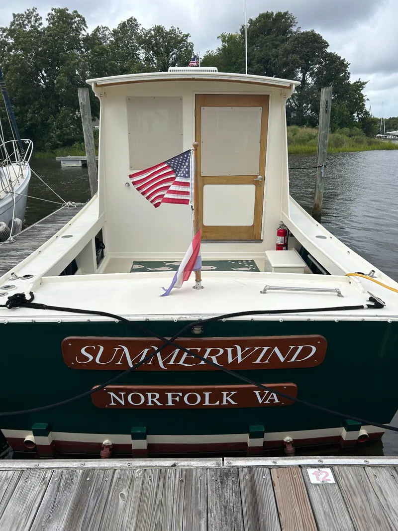 Slide: The Image of Mast & Mallet 34 Rabbit Custom boat, "Summerwind," docked in Norfolk, VA, with American flag. - 3