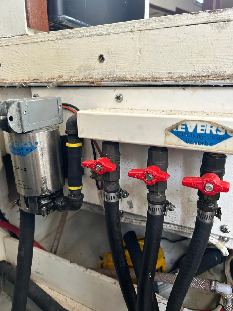 Slide: The Image of Engine compartment of a 1996 Mast & Mallet 34 Rabbit Custom boat with valves and hoses. - 34