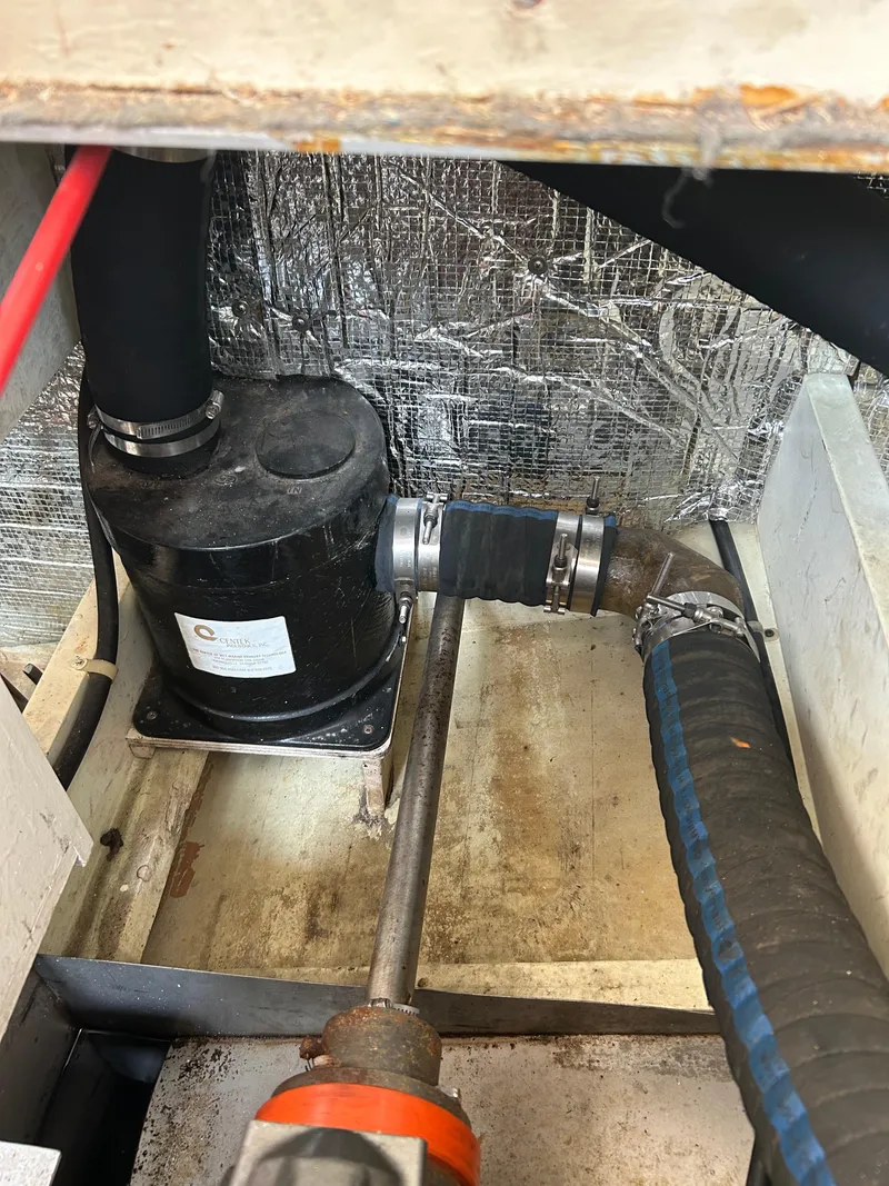 Slide: The Image of Engine compartment of 1996 Mast & Mallet 34 Rabbit Custom boat, showing hoses and pump. - 41