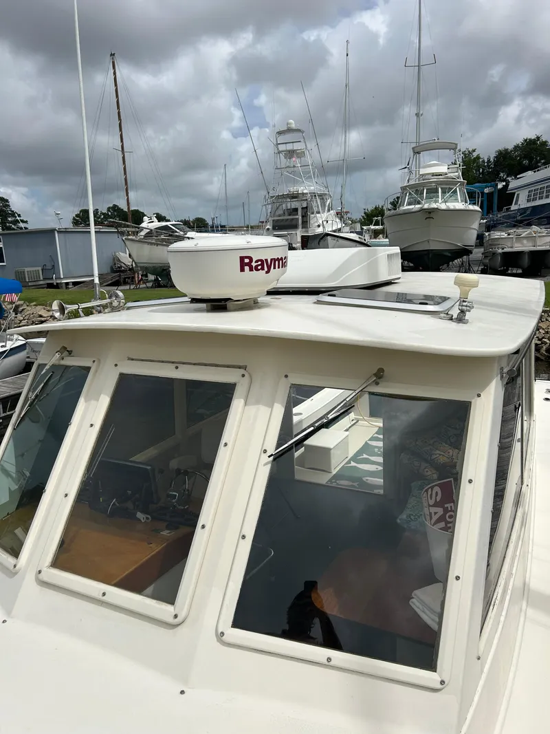Slide: The Image of 1996 Mast & Mallet 34 Rabbit Custom boat with Raymarine radar, docked under cloudy skies. - 7