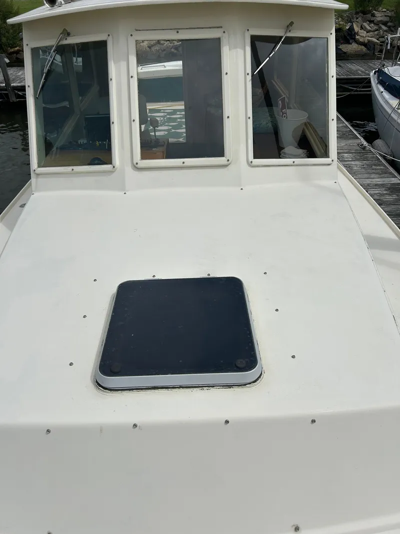 Slide: The Image of 1996 Mast & Mallet 34 Rabbit Custom boat, white deck, docked at marina. - 8