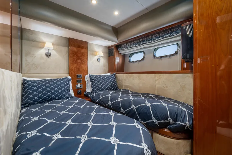 Slide: The Image of Luxurious twin cabin in 2008 Viking Princess 75 yacht with elegant bedding and wood accents. - 12
