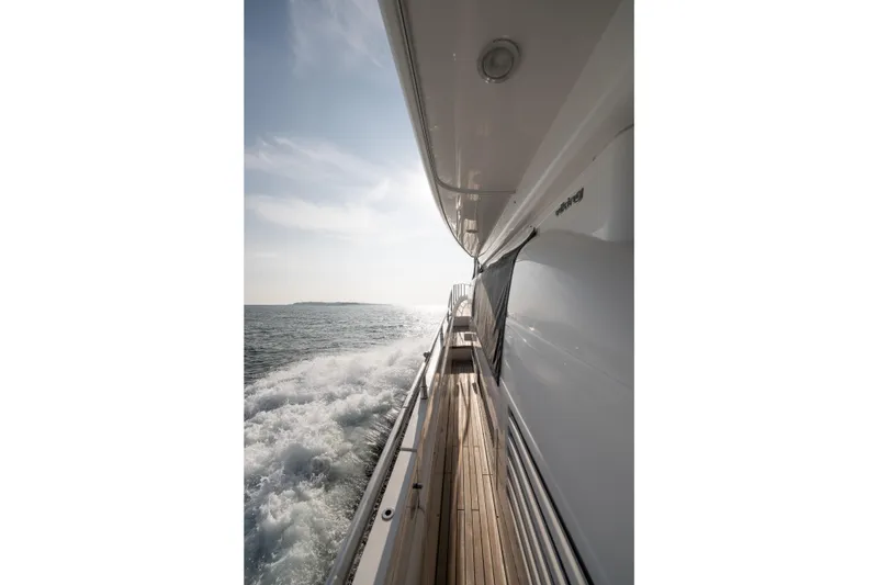 Slide: The Image of Side view of 2008 Viking Princess 75 yacht cruising on open water. - 19
