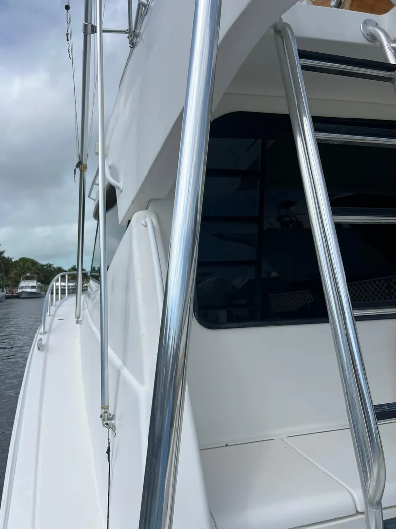 Slide: The Image of 2005 Rampage 45 Convertible yacht with sleek design and chrome railings. - 12