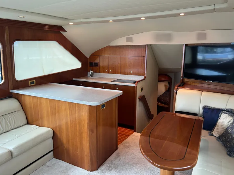 Slide: The Image of Luxurious interior of 2005 Rampage 45 Convertible yacht with wood finishes and seating area. - 15