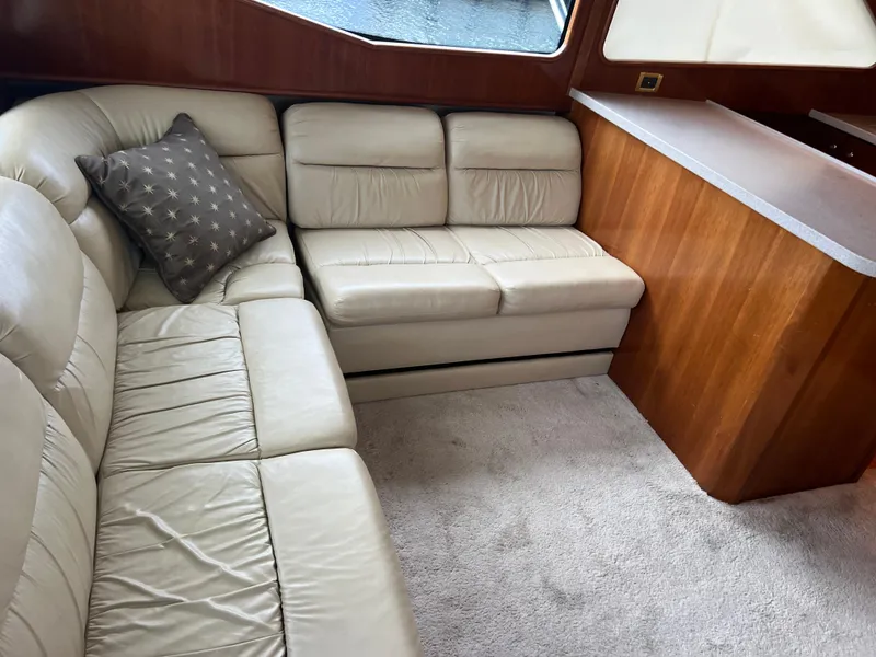 Slide: The Image of Luxurious interior of 2005 Rampage 45 Convertible yacht with beige leather seating. - 16