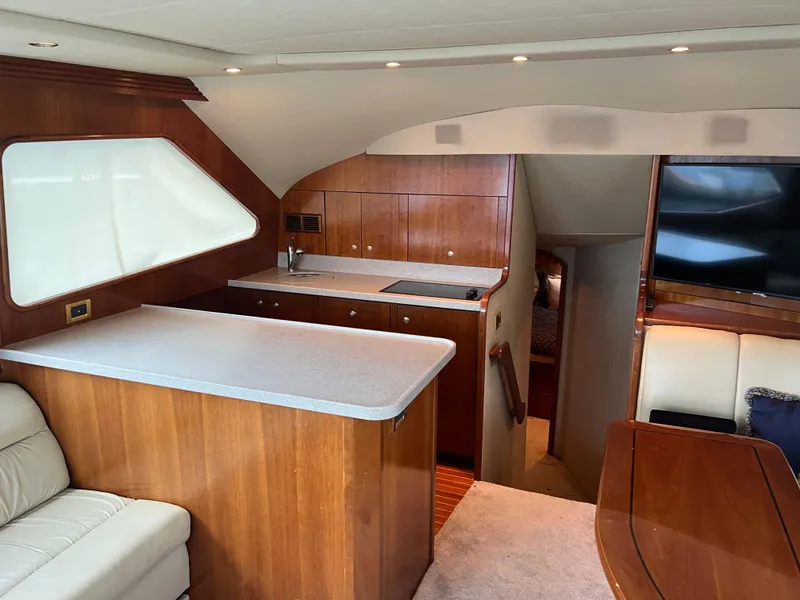 Slide: The Image of Luxurious 2005 Rampage 45 Convertible yacht interior with modern kitchen and seating area. - 17