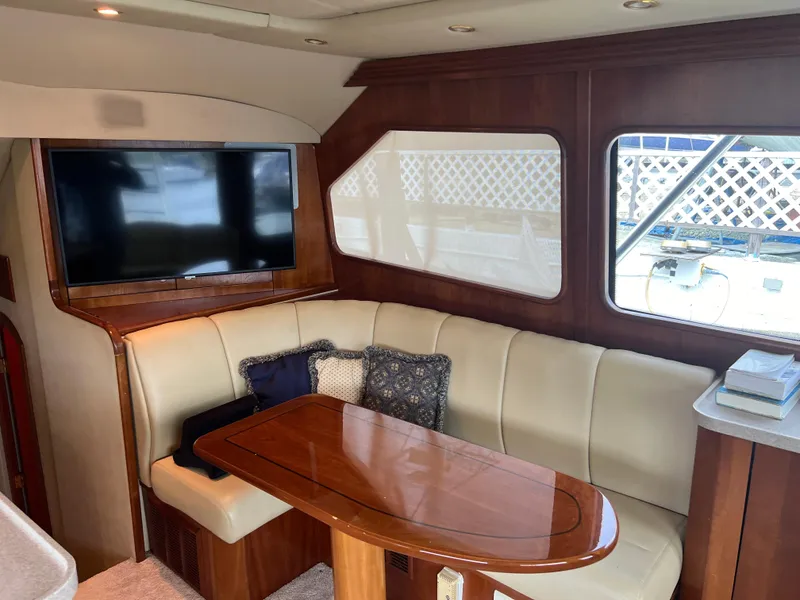 Slide: The Image of Luxurious 2005 Rampage 45 Convertible yacht interior with plush seating and wooden table. - 18