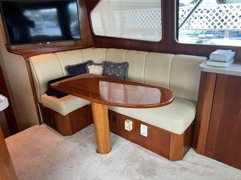 Slide: The Image of Luxurious 2005 Rampage 45 Convertible yacht interior with plush seating and elegant wooden table. - 19