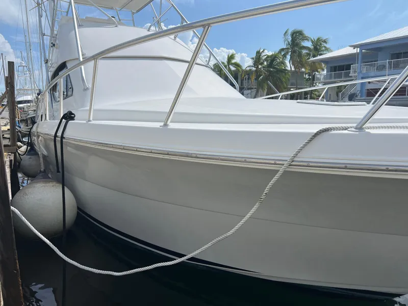 Slide: The Image of 2005 Rampage 45 Convertible yacht docked at marina. - 2