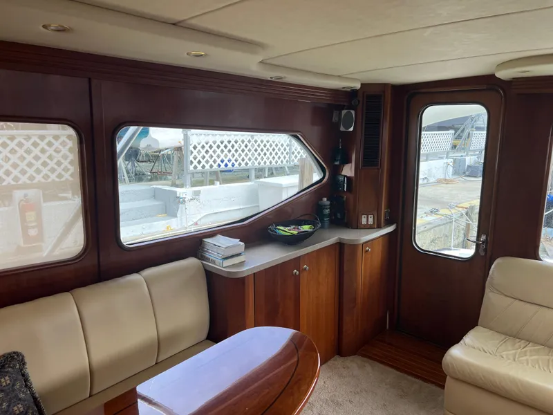 Slide: The Image of Interior of 2005 Rampage 45 Convertible yacht with wood paneling and leather seating. - 20