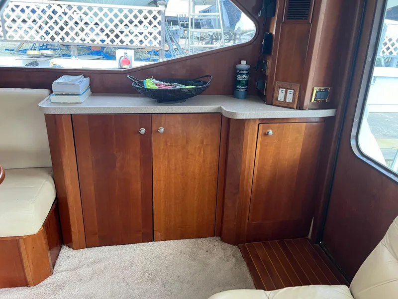 Slide: The Image of 2005 Rampage 45 Convertible yacht interior with wooden cabinets and countertop. - 24
