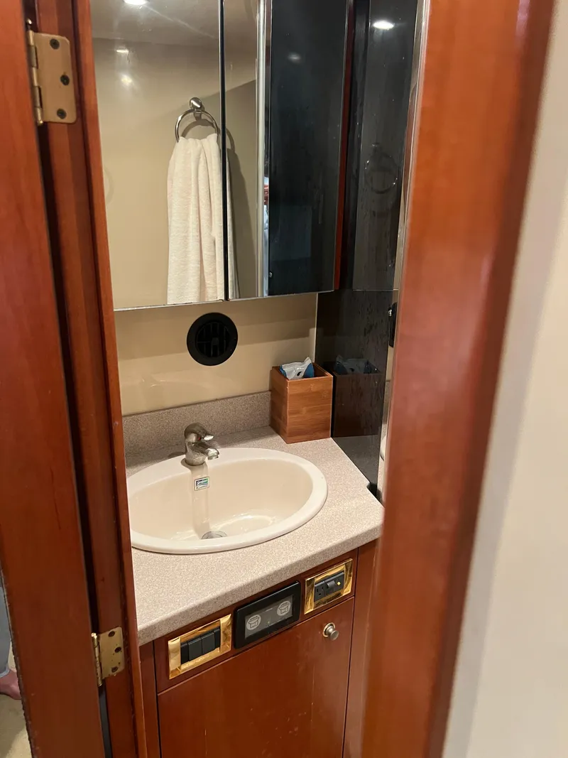 Slide: The Image of 2005 Rampage 45 Convertible bathroom with sink, mirror, and wooden cabinetry. - 37