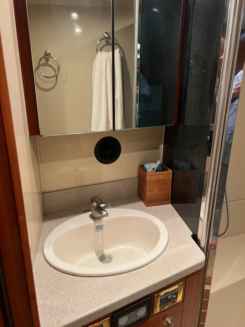 Slide: The Image of Bathroom sink area in a 2005 Rampage 45 Convertible yacht. - 38