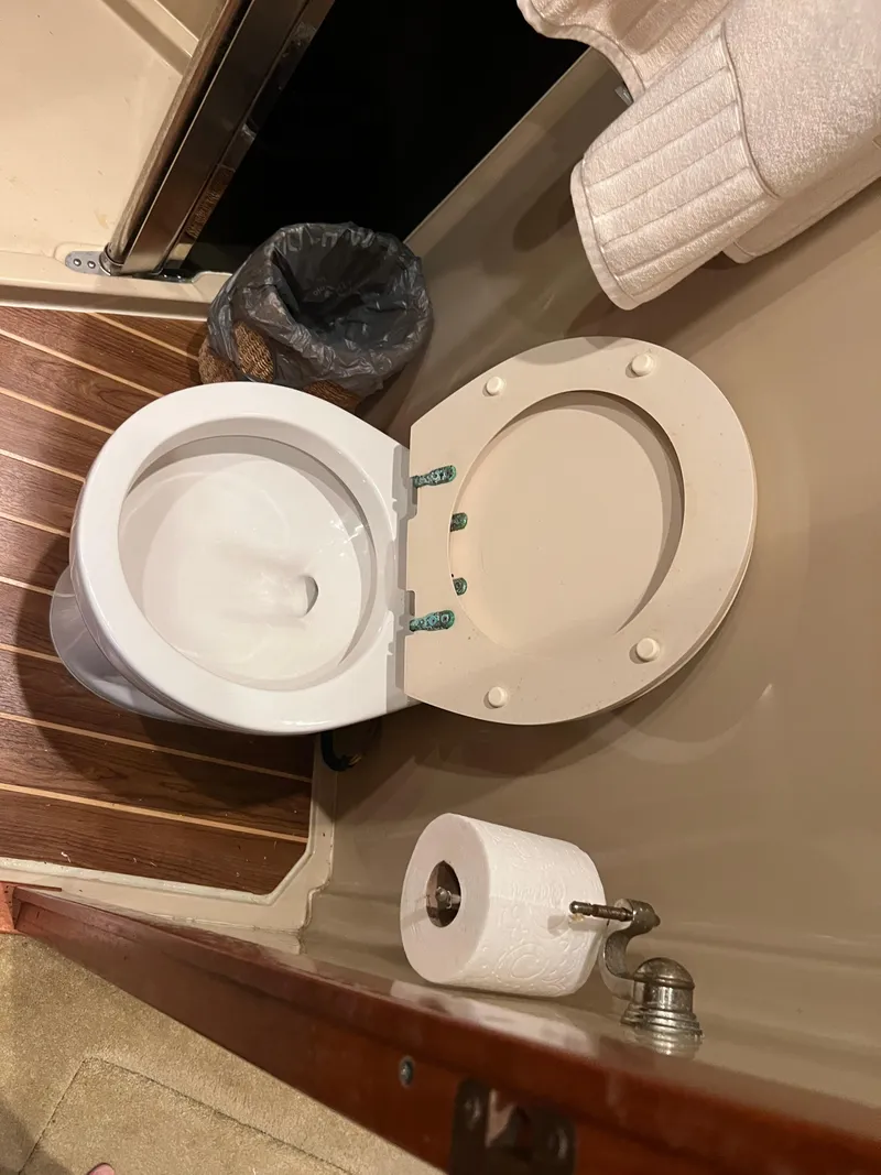 Slide: The Image of Boat bathroom with toilet, wooden floor, and towel rack in 2005 Rampage 45 Convertible. - 39