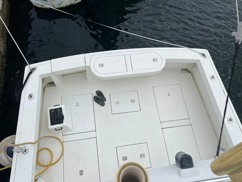 Slide: The Image of 2005 Rampage 45 Convertible boat deck with storage compartments and fishing gear. - 45