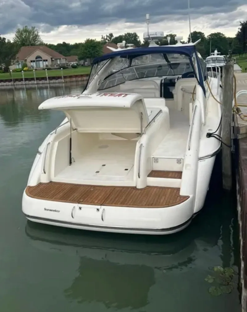 Slide: The Image of 1997 Sunseeker Camargue 47 yacht docked, featuring open deck and sleek design. - 14