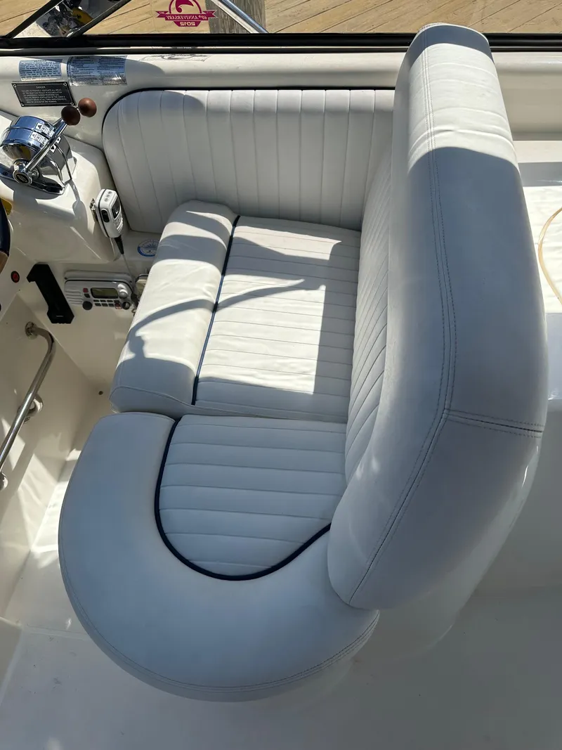 Slide: The Image of White leather seating on a 1997 Sunseeker Camargue 47 yacht, showcasing luxury and comfort. - 17