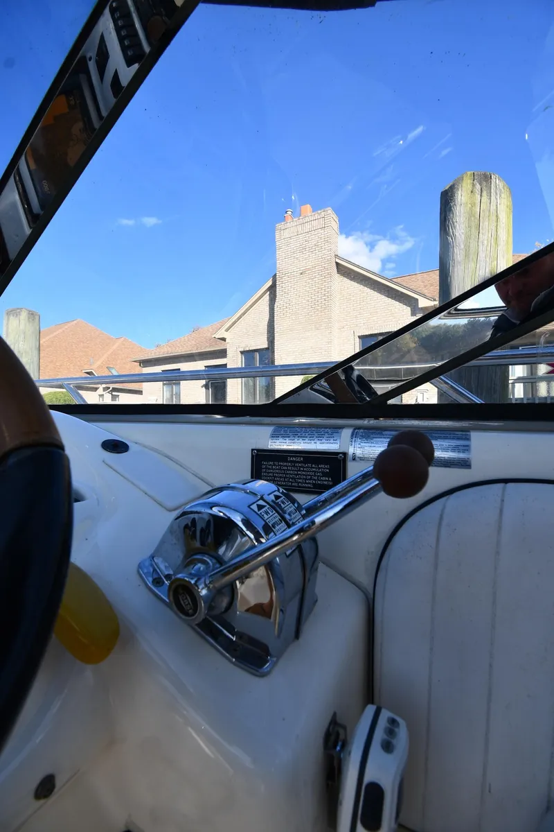 Slide: The Image of 1997 Sunseeker Camargue 47 yacht cockpit with control lever, blue sky background. - 23