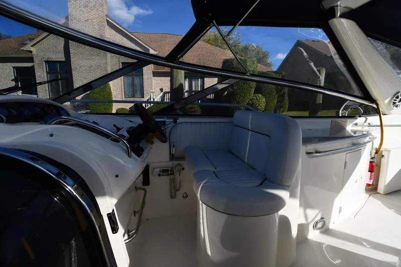 Slide: The Image of Interior view of 1997 Sunseeker Camargue 47 yacht with white seating and steering area. - 24