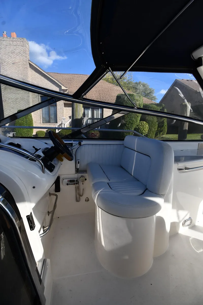 Slide: The Image of 1997 Sunseeker Camargue 47 cockpit with white seating and steering, outdoor view. - 25